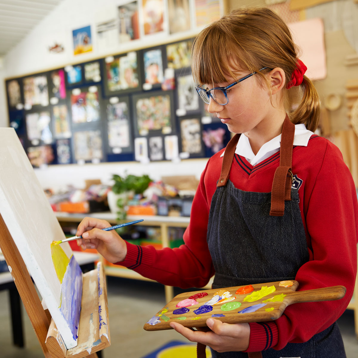 Primary school student at Kingsway Christian College painting in art class