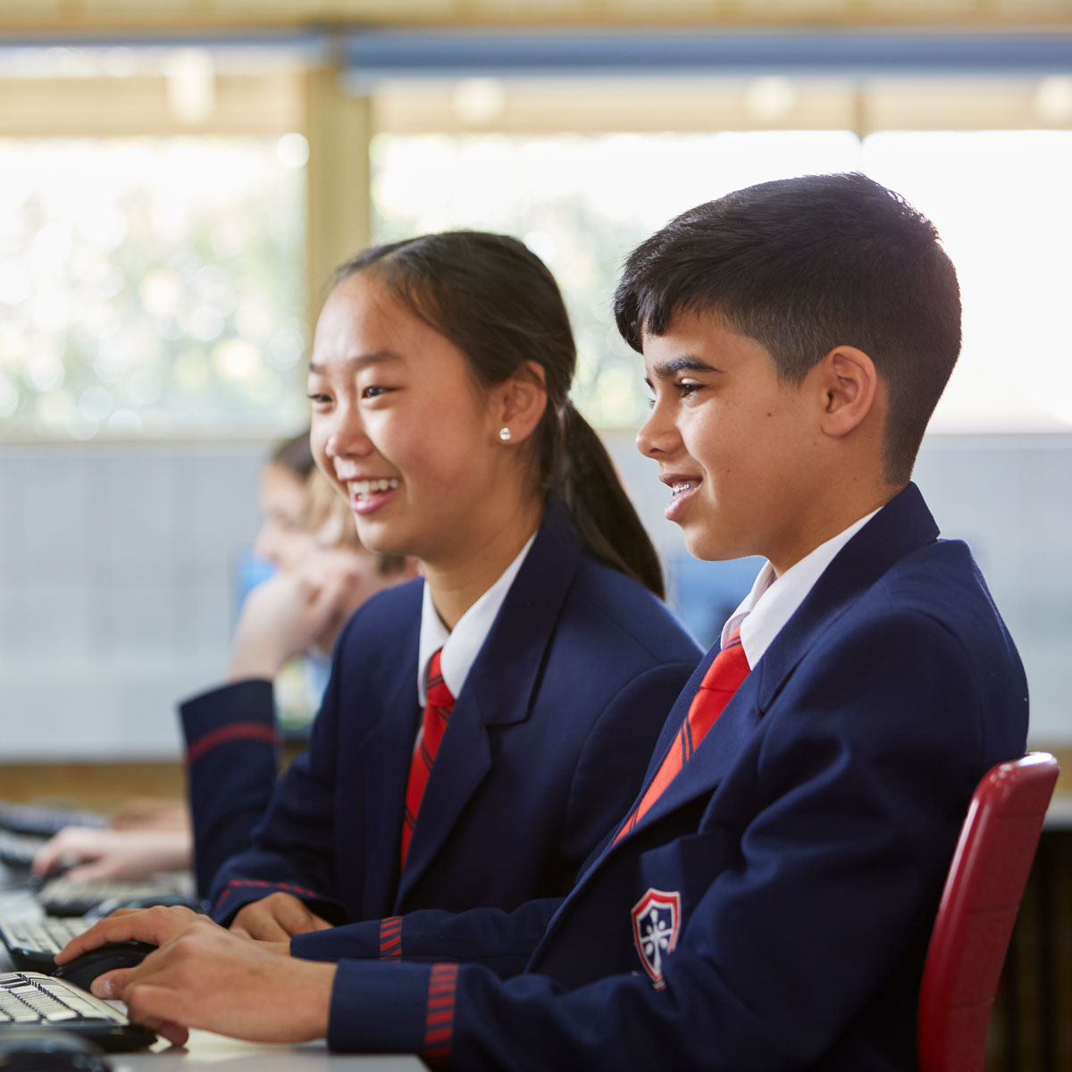 Middle school students at Kinsgway Christian College on computers in classroom