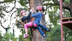 Two school students showing resilience by abseiling on outdoor education school camp